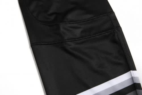 A black ice hockey racing suit featuring smooth fabric and grey striped accents, with a logo on the design.