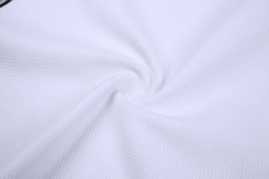A sleeveless baseball singlet made of white textured fabric, featuring a logo on the design.