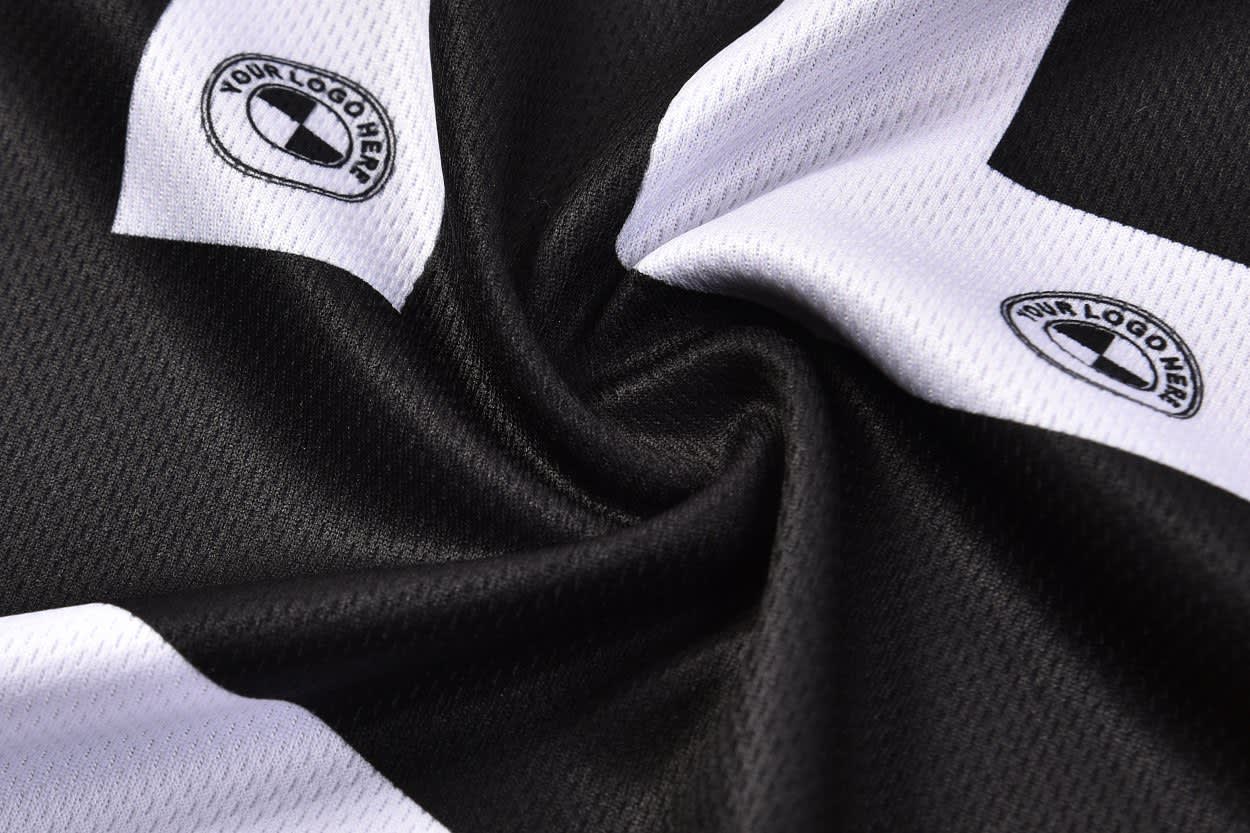 A black and white PLAYER SINGLET featuring two logos, showcasing a textured fabric design.