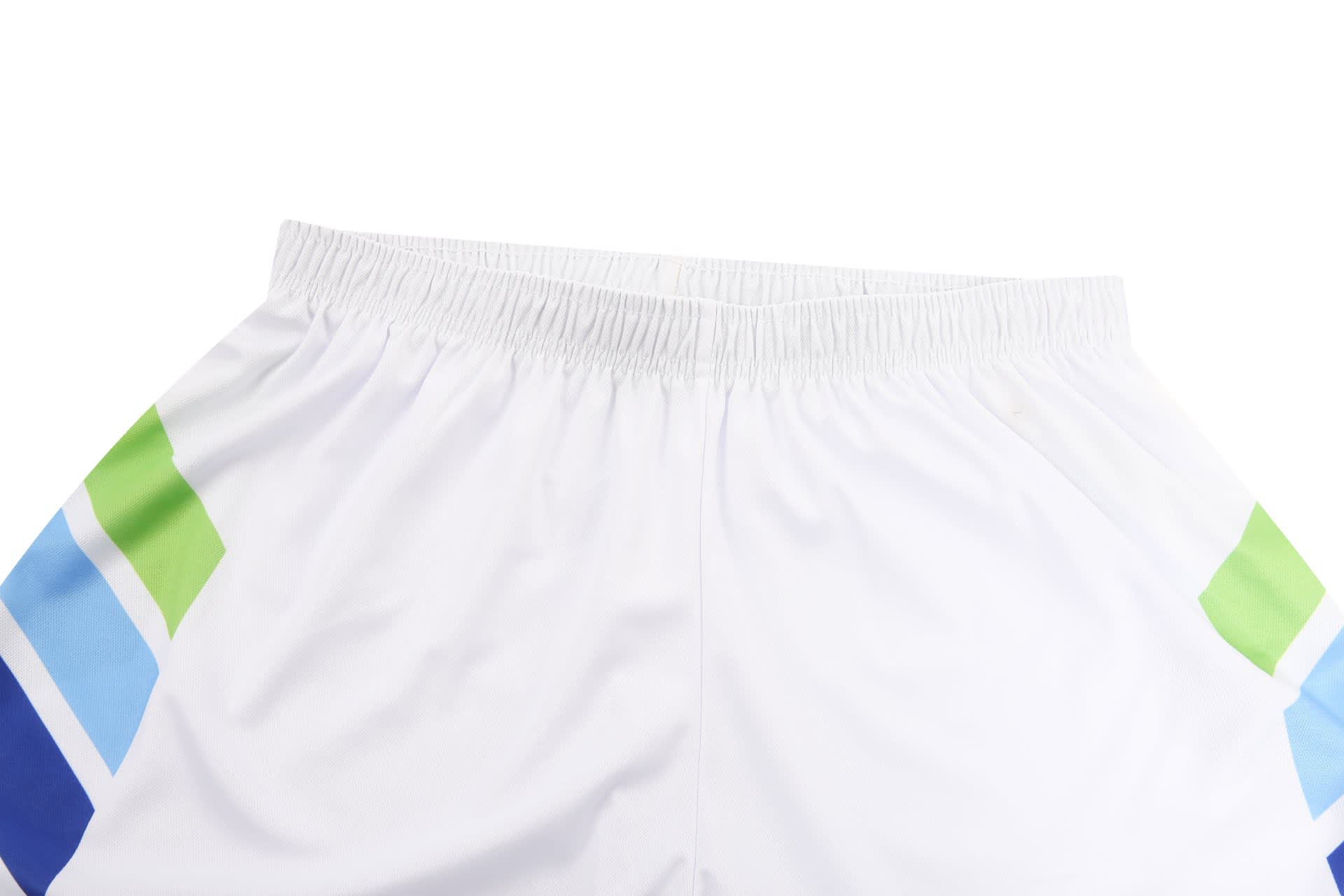 A pair of white tennis uniform shorts featuring blue and green stripes on the sides, with an elastic waistband.