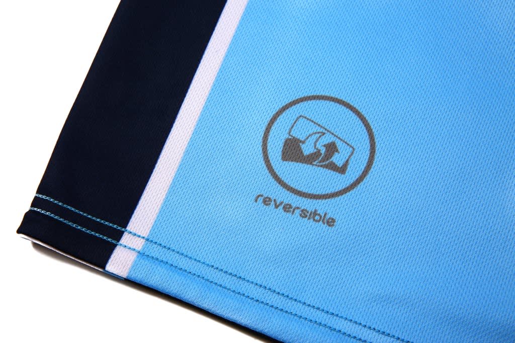 Reversible basketball shorts in light blue and navy, featuring a logo on the hem.
