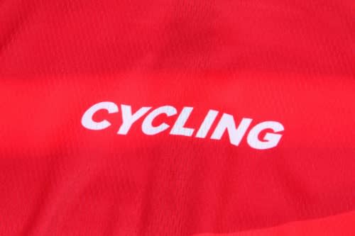 A vibrant red cycling jersey featuring a logo in white. Perfect for sports enthusiasts.