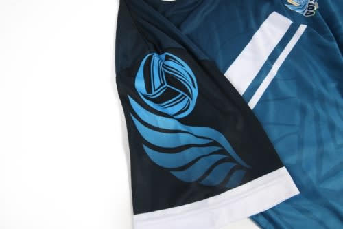 A blue and black volleyball uniform featuring stylised graphics and a logo on the sleeve.