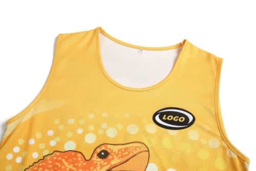 A yellow sleeveless sports uniform featuring an artistic design of a lizard and a logo on the front.