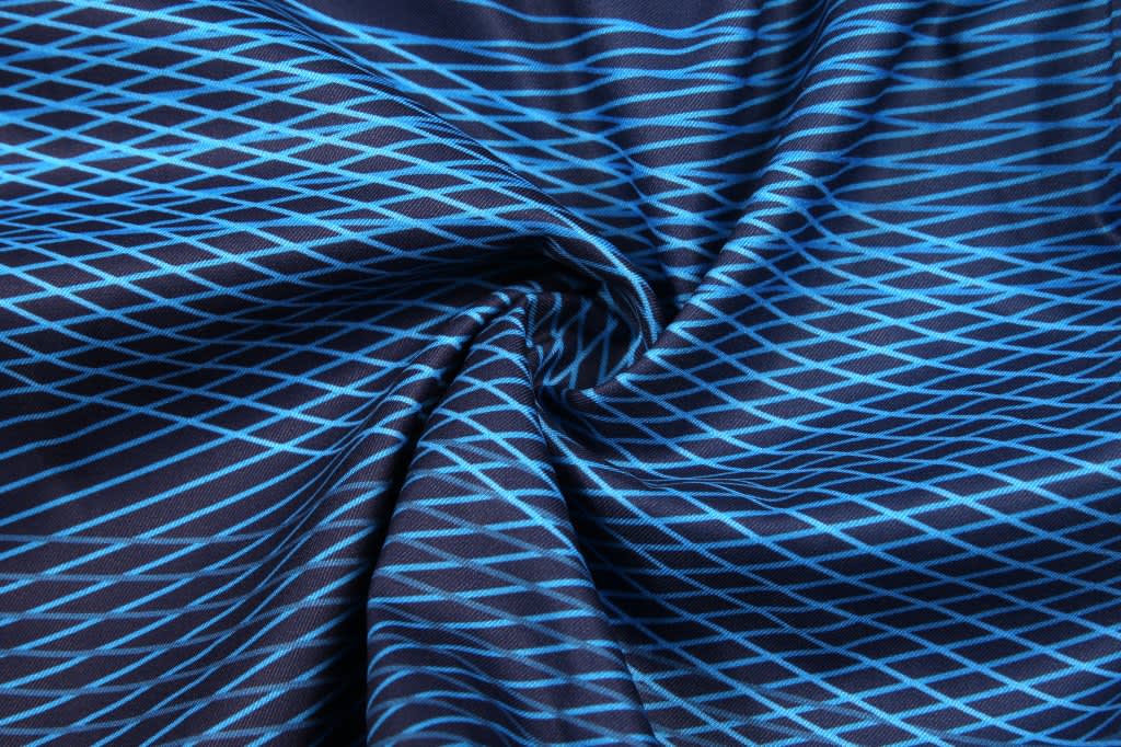 A fabric featuring a blue and black diamond pattern, perfect for sublimation beach shorts.