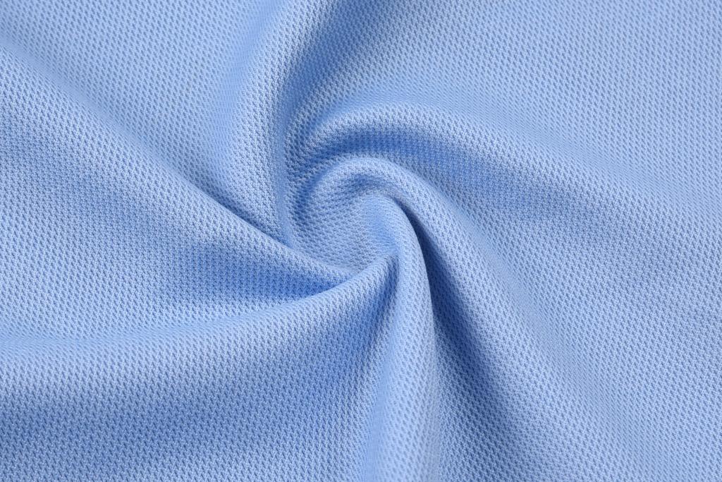 Light blue fabric displaying a textured pattern, ideal for casual wear. The material is soft and flexible.