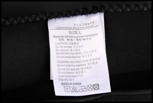 A label featuring washing instructions and care details for a black anti-chlorine swimming coat made of neoprene and nylon.