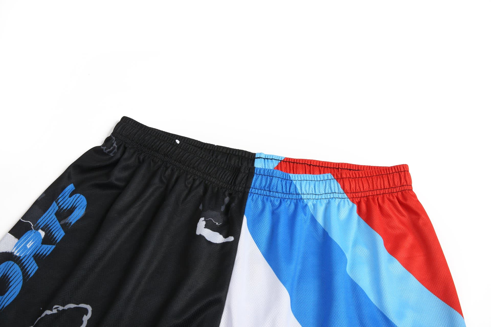 Aboriginal shorts featuring a black and blue design on one side and a red and white pattern on the other.