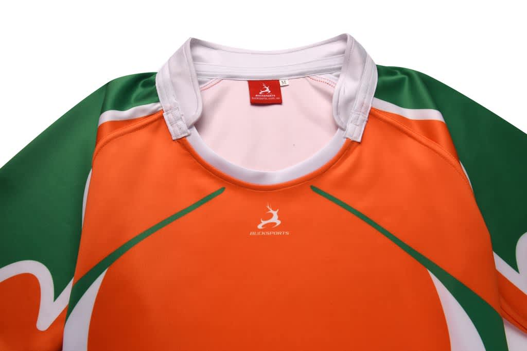 An orange rugby tee with green accents, featuring a collar and a logo on the chest.