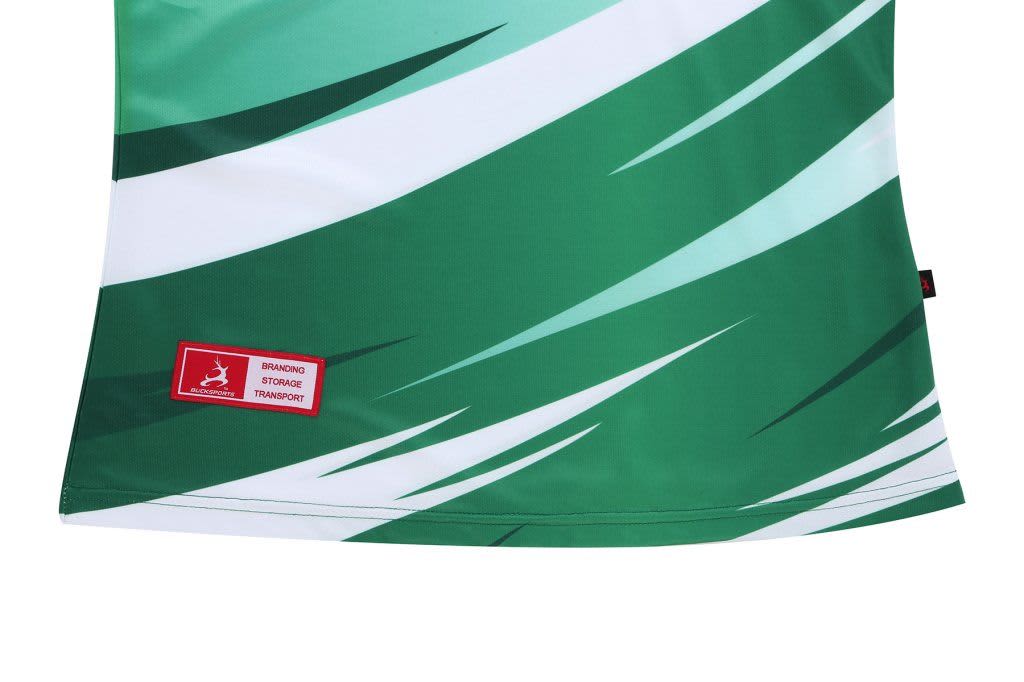 A green and white golf club uniform features dynamic wave patterns and includes a branding logo.