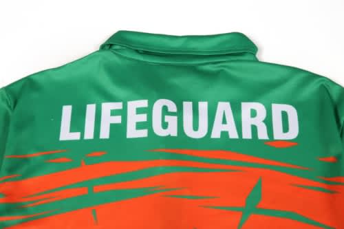 A vibrant green and orange suit with a collar, featuring the word "LIFEGUARD" prominently displayed.
