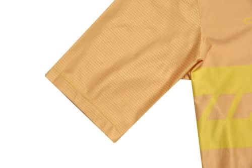 A sports jersey in yellow and light orange, featuring short sleeves and a subtle texture, with a logo on the design.