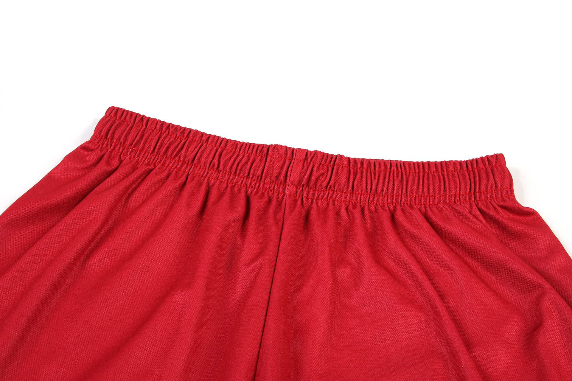 Red basketball uniform women's shorts featuring an elastic waistband. Includes a logo on the fabric.