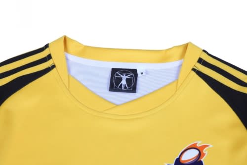 A yellow hoodie with black sleeves and a logo at the neckline.