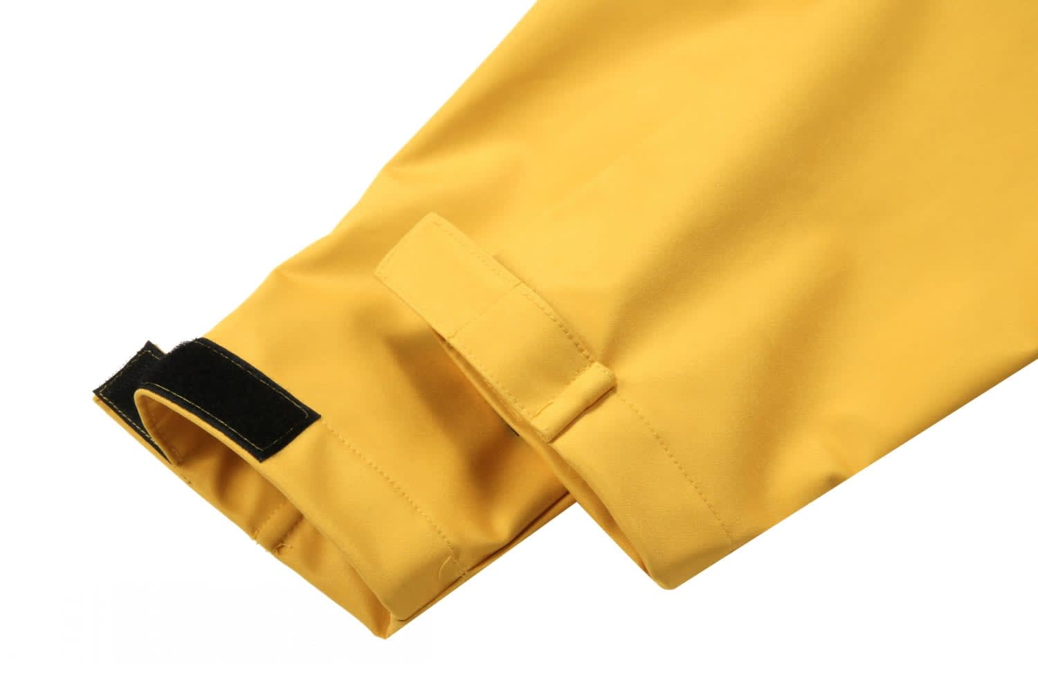 A close-up of a yellow softshell jacket with a velcro adjustment at the cuff and a logo on the sleeve.