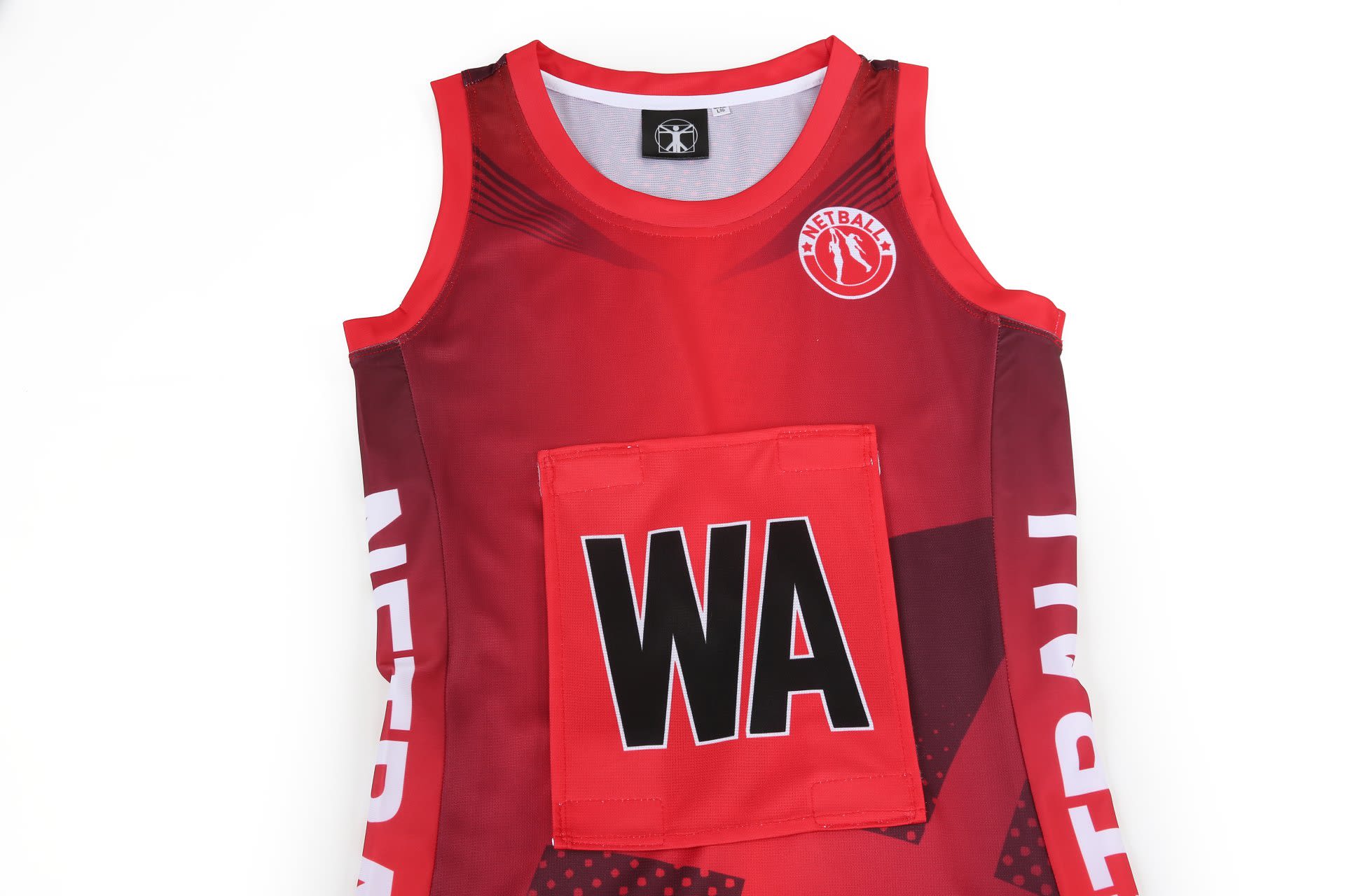 A red netball dress featuring a white design and a central pocket, with a logo on the neckline.