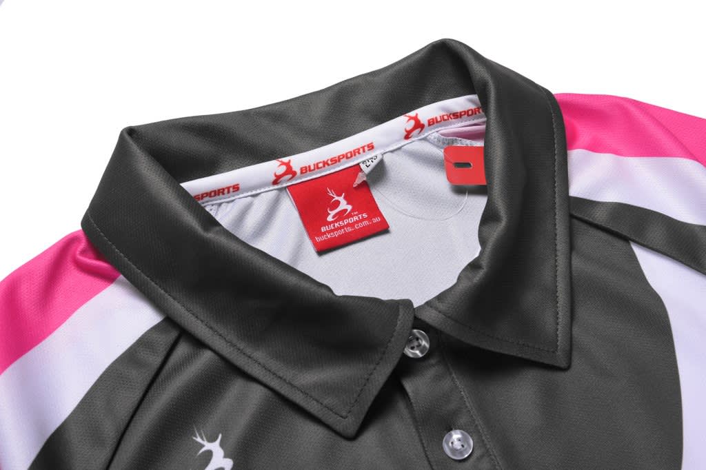 A grey and pink sublimated polo featuring a collar and tag, with a logo visible inside.