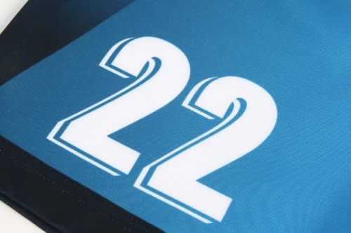A close-up of a blue sports jersey featuring the number 22, with a black trim and logos present.
