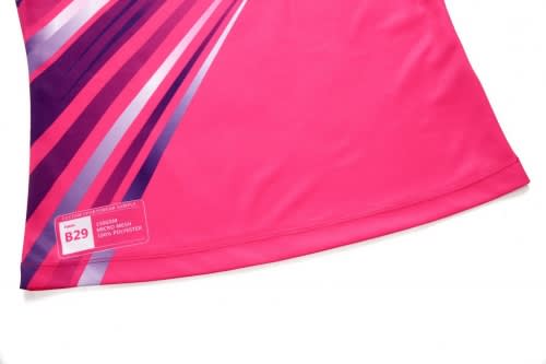A pink sports uniform featuring bold purple and white design elements, with a small logo on the side.