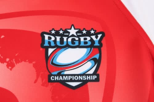 A red rugby uniform featuring a logo and graphic design elements associated with rugby.