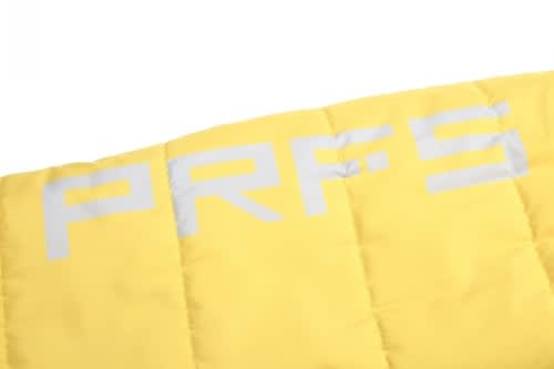 A close-up of a bright yellow fabric with quilted texture and a logo in grey.