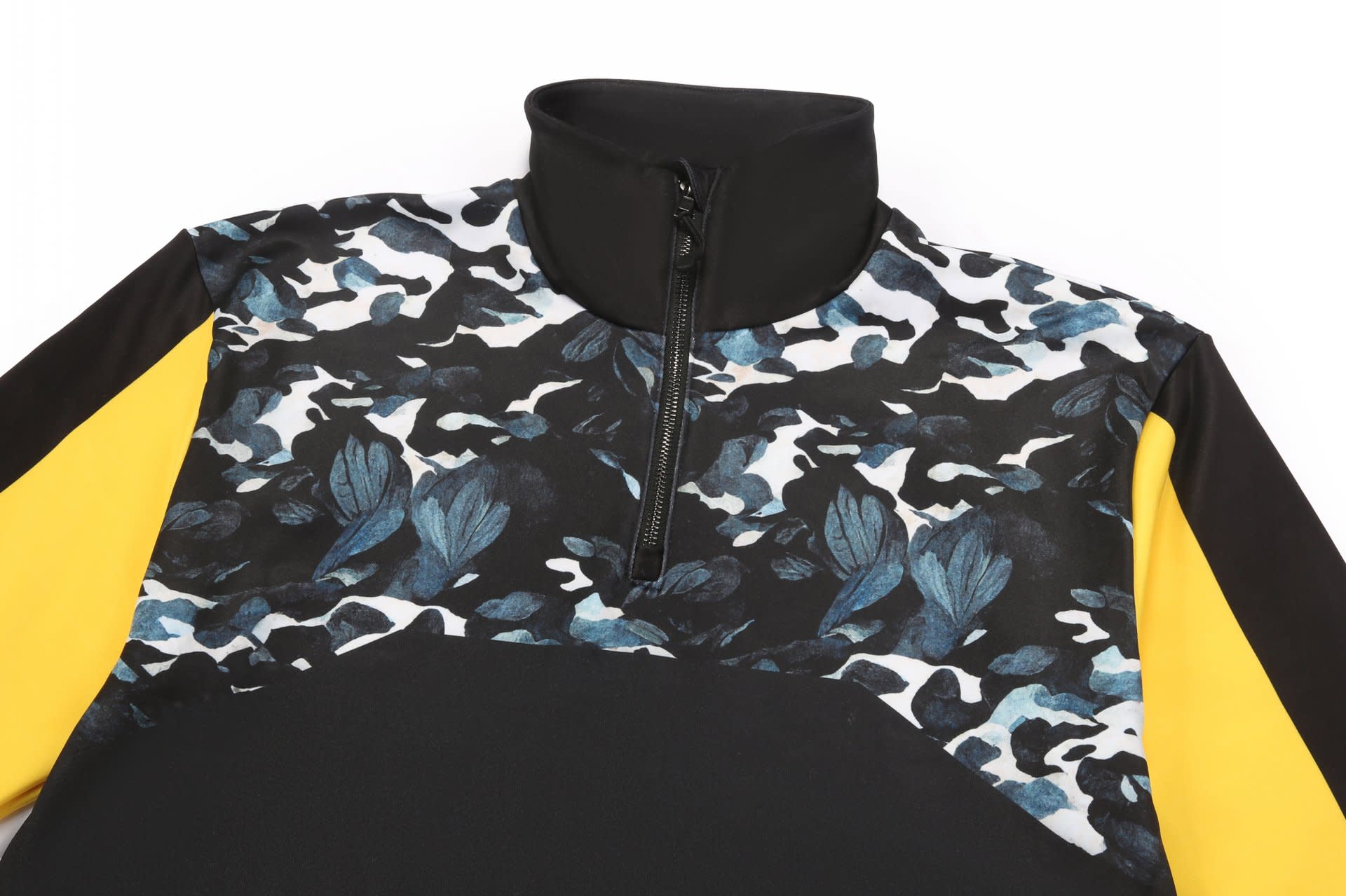 A black and yellow pullover featuring a floral camouflage pattern with shades of blue and black. It has a half-zip collar.