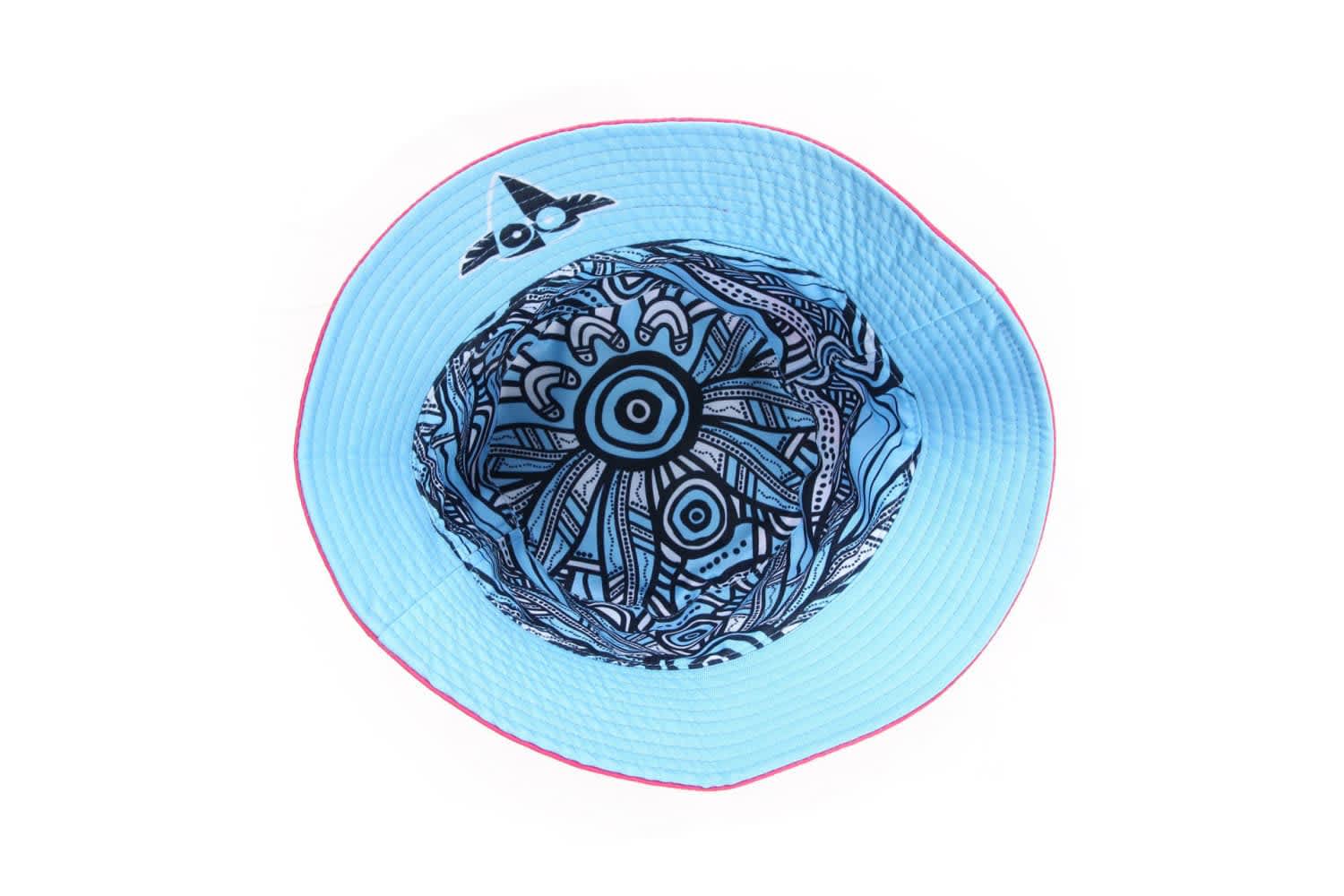 A reversible bucket hat with a blue exterior and a detailed black and blue patterned interior, featuring a logo.