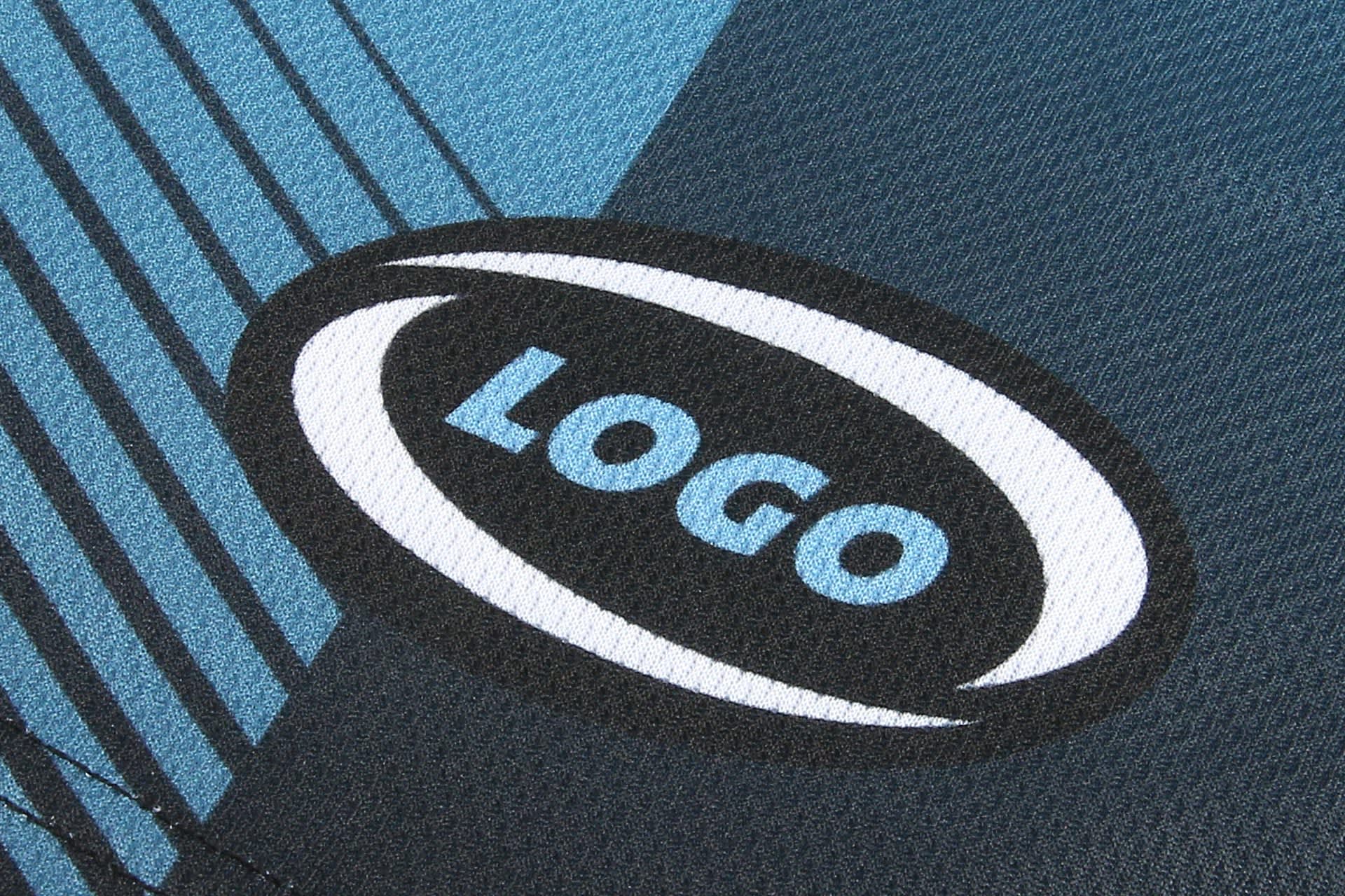 A close-up of a dark blue athletic uniform featuring a logo and textured fabric design in lighter blue tones.