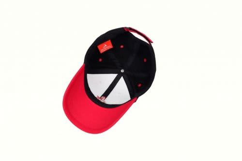 A sport cap featuring a red peak and a black crown. The interior is white and it has a logo.
