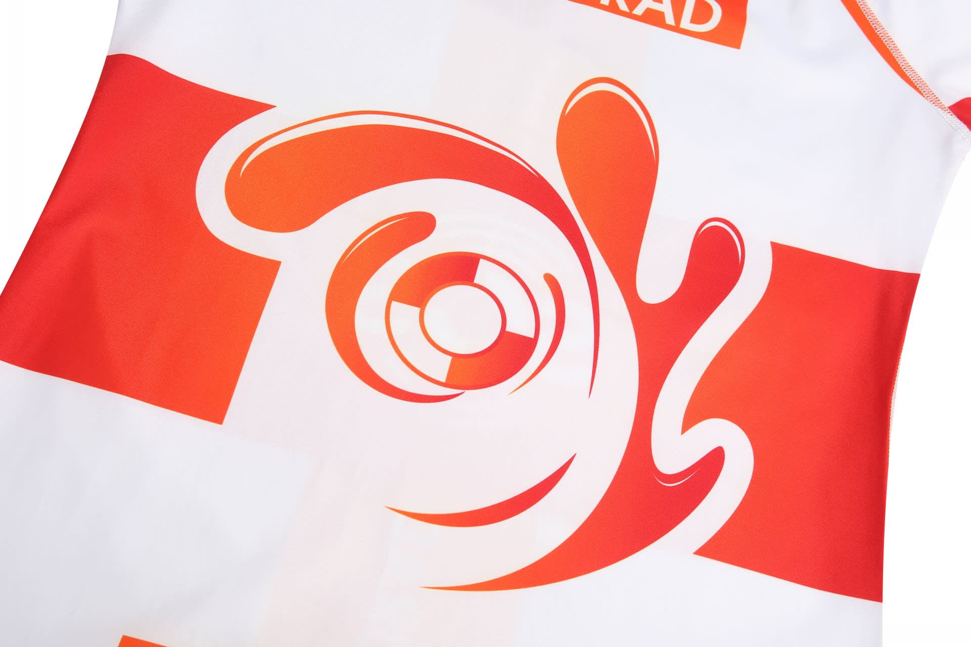A vibrant red and white swimming suit featuring an abstract splash design and a logo.