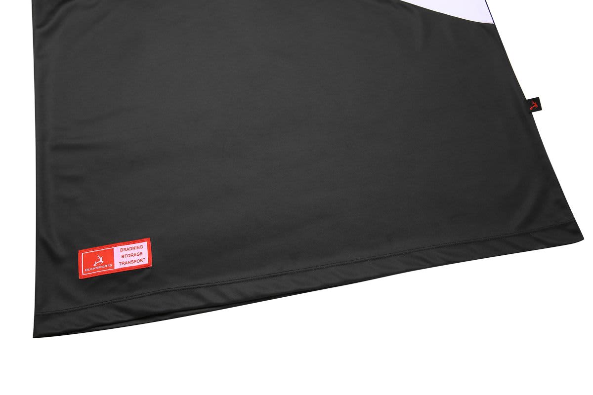 A black singlet displayed on a flat surface, featuring a logo and a contrasting white panel.