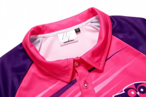 A pink and purple sports polo shirt with a collar and a logo at the front.