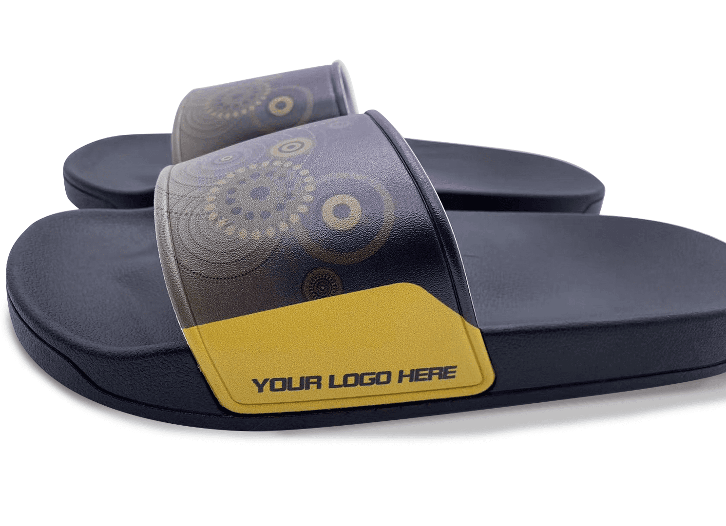 A pair of navy blue slippers with a patterned strap and a space for a logo on the side.