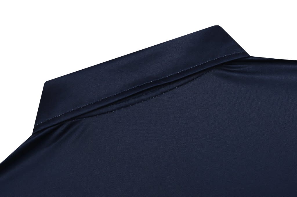 A navy blue polo shirt collar with a smooth finish, featuring a subtle branding logo at the back.