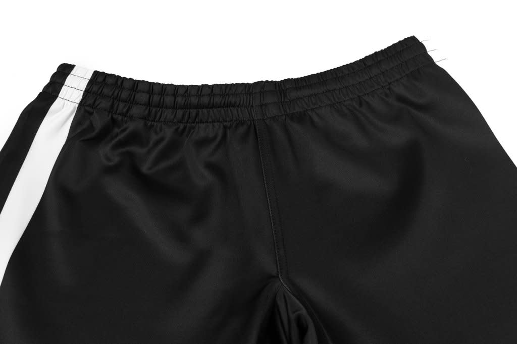 Black rugby shorts featuring a gusset crotch with a white side stripe and an elastic waistband.