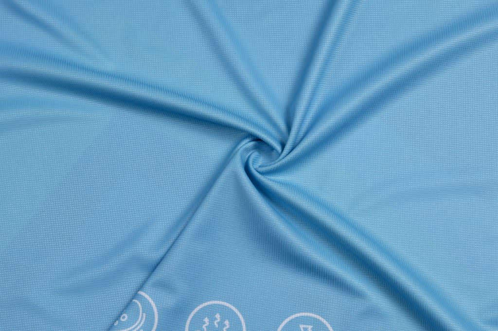 A light blue fabric with a smooth texture and a logo along the bottom edge.