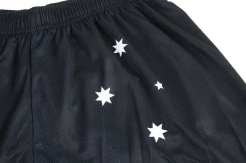 Black sports shorts with a mesh texture featuring white star designs scattered across the fabric.