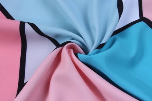 A fabric with pink and blue sections, featuring black outlines, suitable for custom shirts.