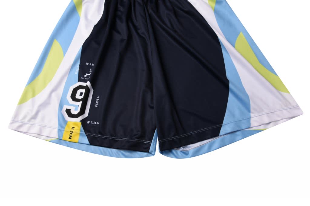 A pair of black and blue soccer shorts featuring a colourful design and a logo.