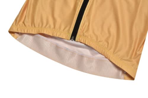 A close-up of a yellow sports jersey featuring a zip closure and a textured hem, with a logo present.