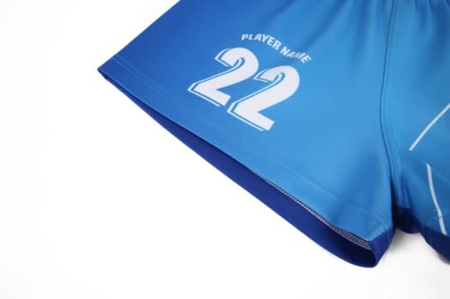 A blue sports jersey featuring a white number 22 and a logo. The fabric appears lightweight and flexible.