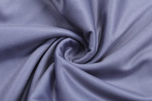 A textured fabric in a soft, muted shade of blue, featuring a smooth finish and a slight sheen.