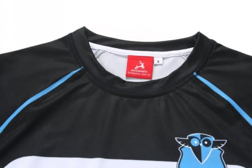 A black swimming instructor uniform with blue accents, featuring an owl logo and a tag.