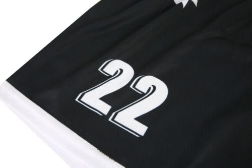 A black sports jersey featuring white numbers, including "22," and a logo.