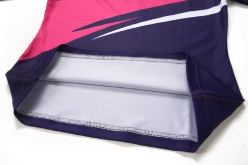A purple and pink swimming coat with a smooth inner lining, featuring a logo on the fabric.