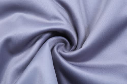 A smooth, light blue fabric with a subtle sheen, featuring a swirl pattern. Ideal for sports uniforms and jackets.