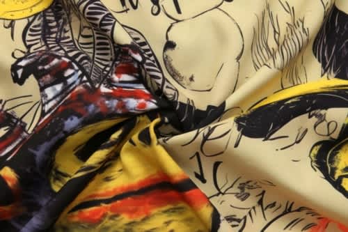 A vibrant fabric featuring a blend of yellow, red, and black patterns, designed for varsity jacket lining.