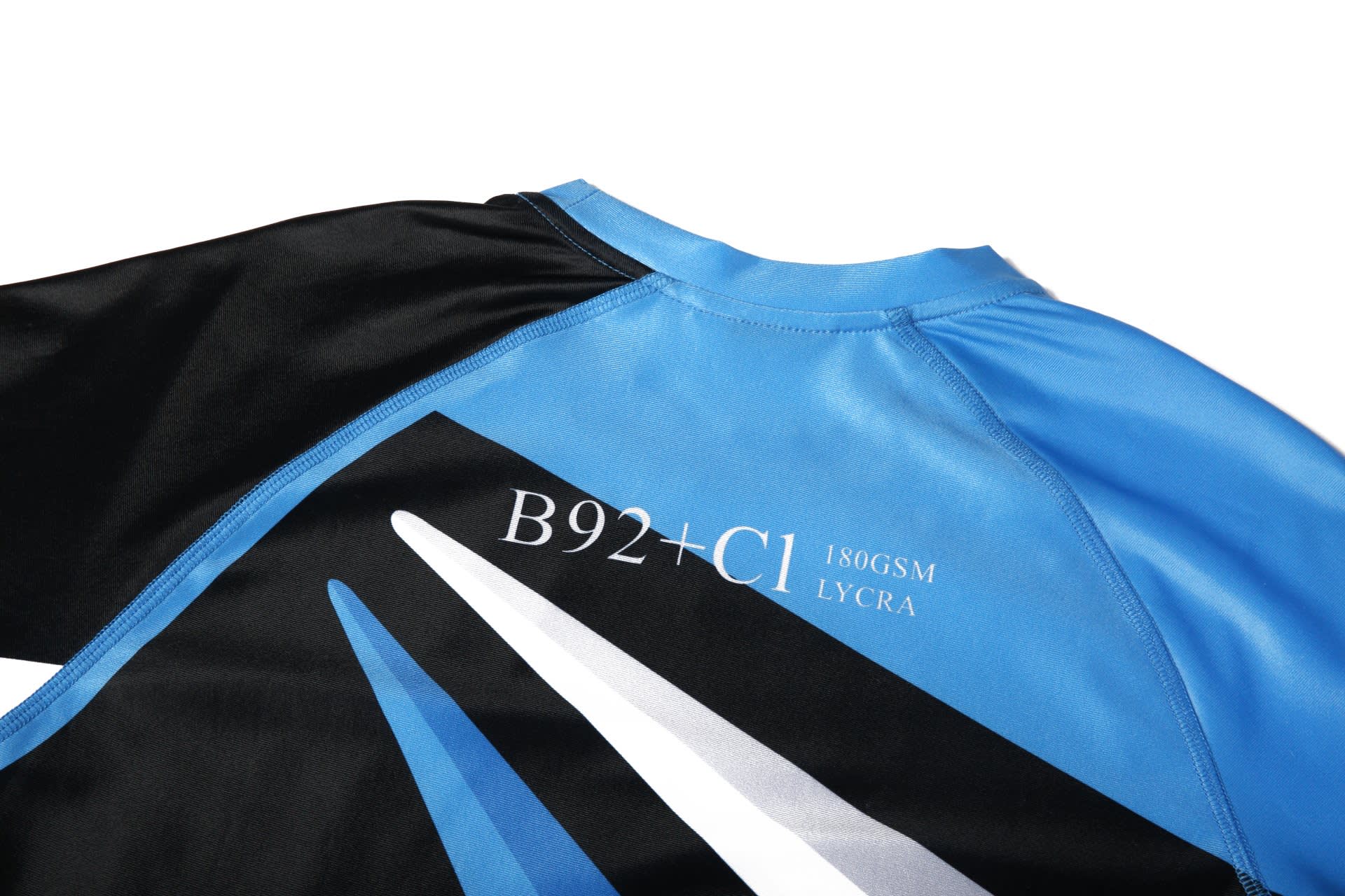 A black and blue t-shirt featuring a design with geometric elements and a logo. Made from Lycra material.