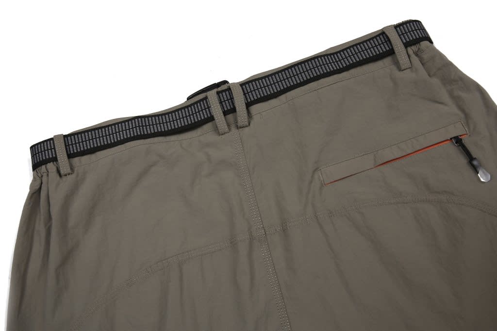 Windbreaker pants in olive green with a black waistband and a zip pocket on the back. Features a logo on the waistband.