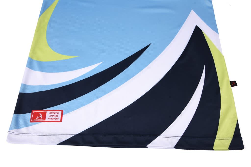 A fabric featuring a blue and black design with green and white accents and a small logo in the corner.